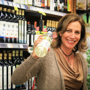 Beth Greer holding a bottle of white vinegar at the store