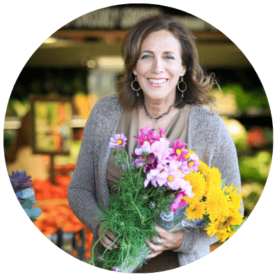 Beth Greer holding flowers at the Farmer's Market